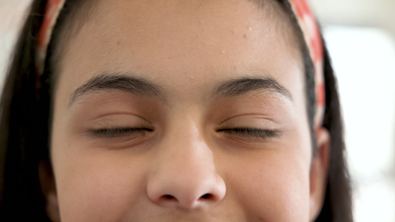 Smiling girl with headband enjoying school day, close-up of face