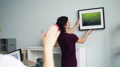 couple hanging a picture