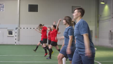 female soccer athletes doing pregame workout of field