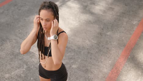 High-angle-view-of-young-African-American-woman-wearing-earphones-in-the-city-4k