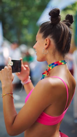 woman at pride parade taking a photo