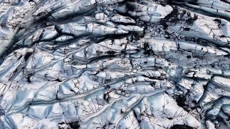 stunning top-down view of dramatic crevasses at sólheimajökull, mýrdalsjökull glacier, iceland.