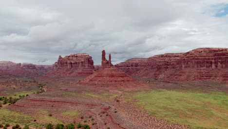 grassy fields with rocky formations behind