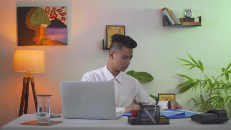 Serious-young-Indian-african-businessman-Working-on-his-laptop-in-the-office,-career-opportunities-concept