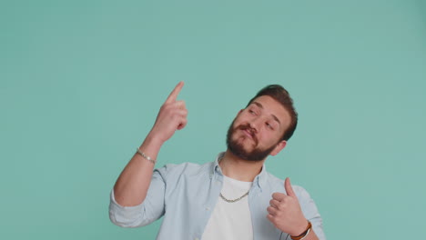 Lebanese-man-showing-thumbs-up-pointing-empty-place-advertising-area-for-commercial-text,-copy-space