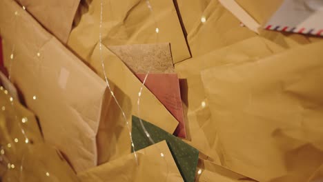assortment of envelopes and letters with festive colors, softly lit for a warm ambiance