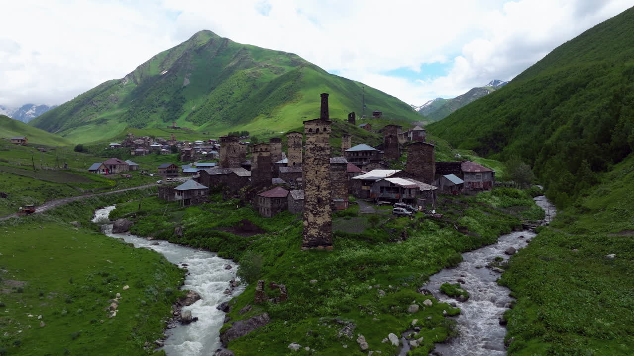 Medieval Svan Towers Over Preserved Village Of Ushguli In Svaneti, Georgia. Aerial Pullback Shot