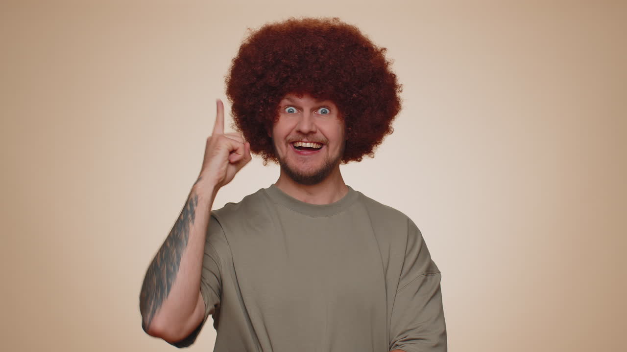 Inspired adult man pointing finger up, showing Eureka gesture, solution, idea, inspiration, answer