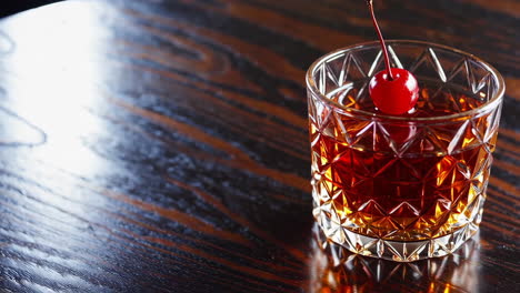 dark wood table with a cocktail