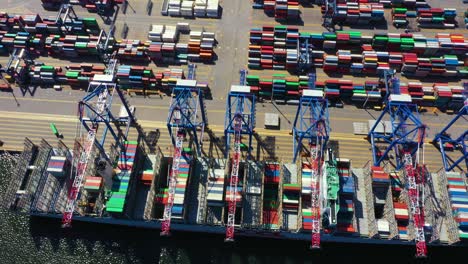 container ship in import export and business logistic, by crane, trade port, shipping cargo to harbor, international transportation, business logistics concept, aerial view