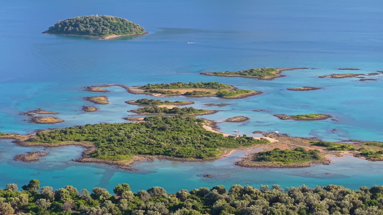 Drone performs an orbit around the lush green oasis of Lichadonisia islands, highlighting vibrant nature and clear blue waters by the sea