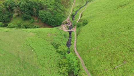 Aerial-shot-of-three-shire-heads-at-Dane-Valley-way-surrounded-with-greenery-in-England-during-daytime