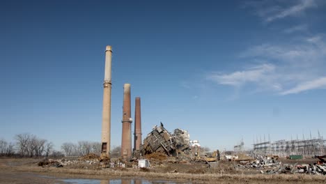 old smoke stacks next to demolished coal fired power plant ruins