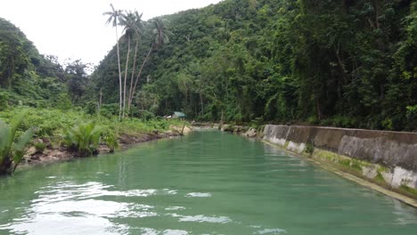 Secluded-Cottage-house-on-a-creek-hidden-in-lush-vegetation-of-tropical-jungle