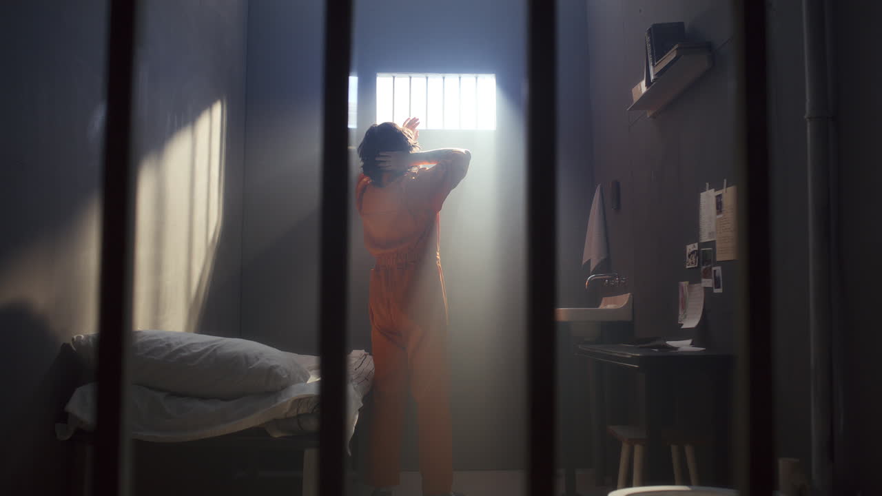 Man Walking around Prison Cell, Looking through Window and Resting on Bed