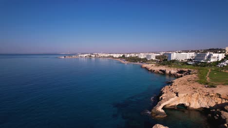 areal drone shot of ayia napa coast, beach and love bridge on clear warm summer morning