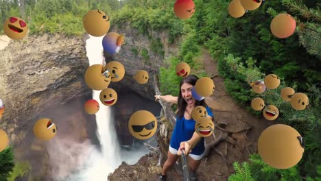 emoji icons with woman taking a selfie in the background