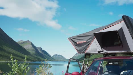 vehicle rooftop tent by the lakeshore near gryllefjord fishing village in senja, norway