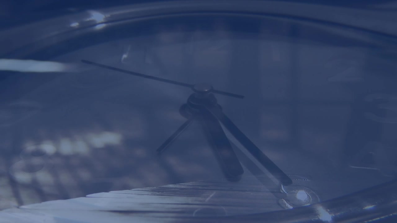 Animation of moving clock over people walking on street