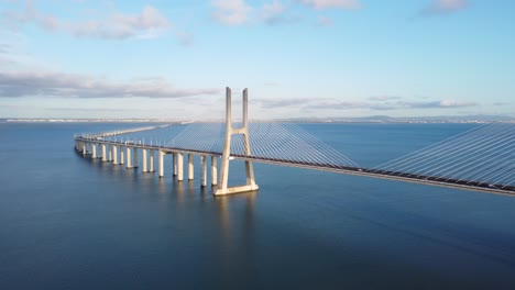 aerial approaching shot of the huge vasco da gama bridge in lisbon, portugal