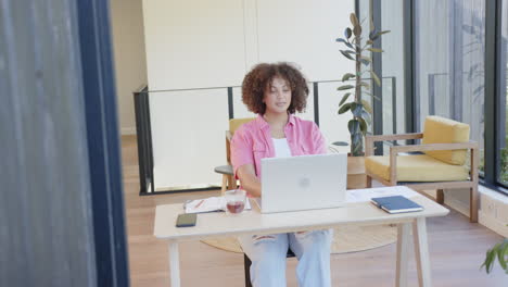 stretching arms, plus size woman taking break from work at home office desk
