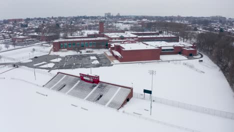 aerial of school college university campus athletic fields covered in winter snow