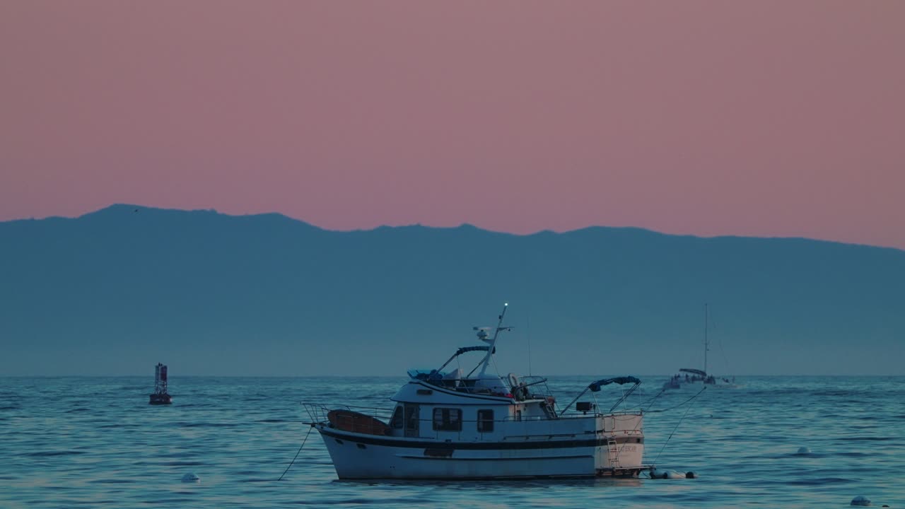 Fishing Boat Anchored off Santa Barbara Coast at Dusk with Mountains and Pastel Sky