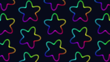el patrón de estrellas de color arco iris flota en formación circular sobre un fondo negro.