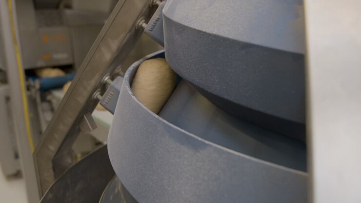 White dread being molded by a rolling machine