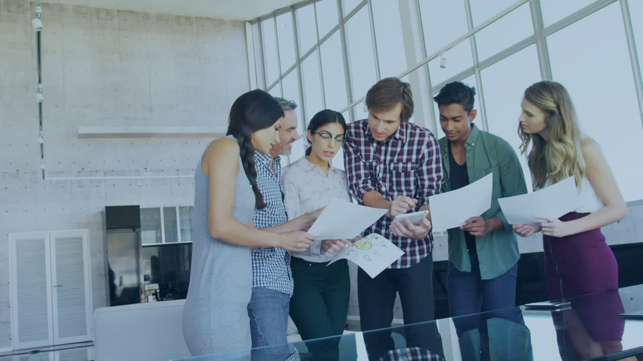Team assembling around table passing charts with animated overlay appearing for business analysis