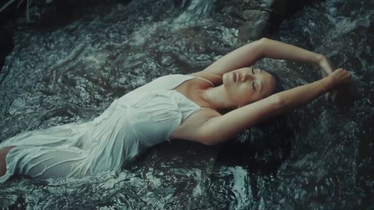 Woman in White Dress Relaxing in a Flowing Stream