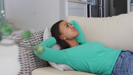 african american woman lying on the couch at home