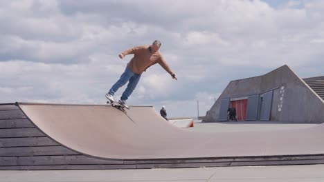 professional middle age male skateboard on mini vert ramp, copenhagen