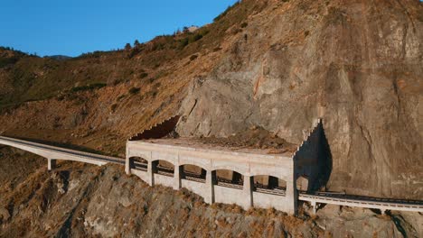 car driving under the rock shed on california highway 1