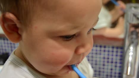 cute baby boy brushing his teeth