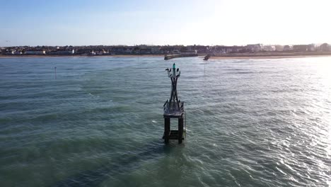drone-shot-of-a-marine-beacon-in-courseulles-sur-mer-on-a-beautiful-sunset