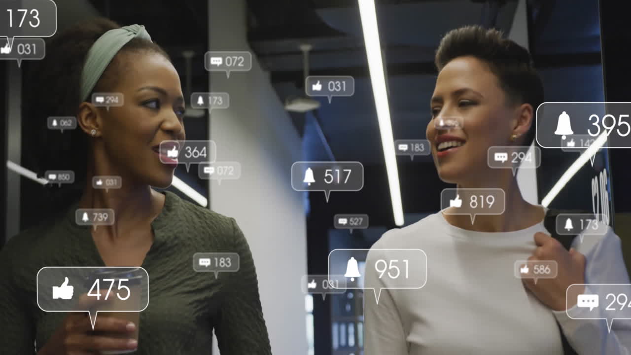 Two colleagues walking office corridor, showing floating social media icons for marketing