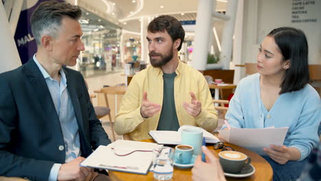 a work team has a business meeting in a coffee shop