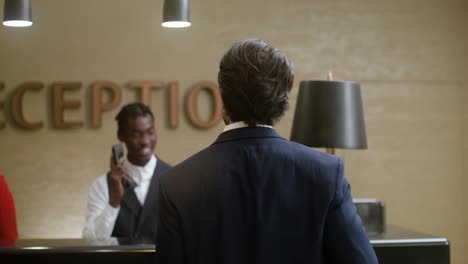 young man checking in at the hotel