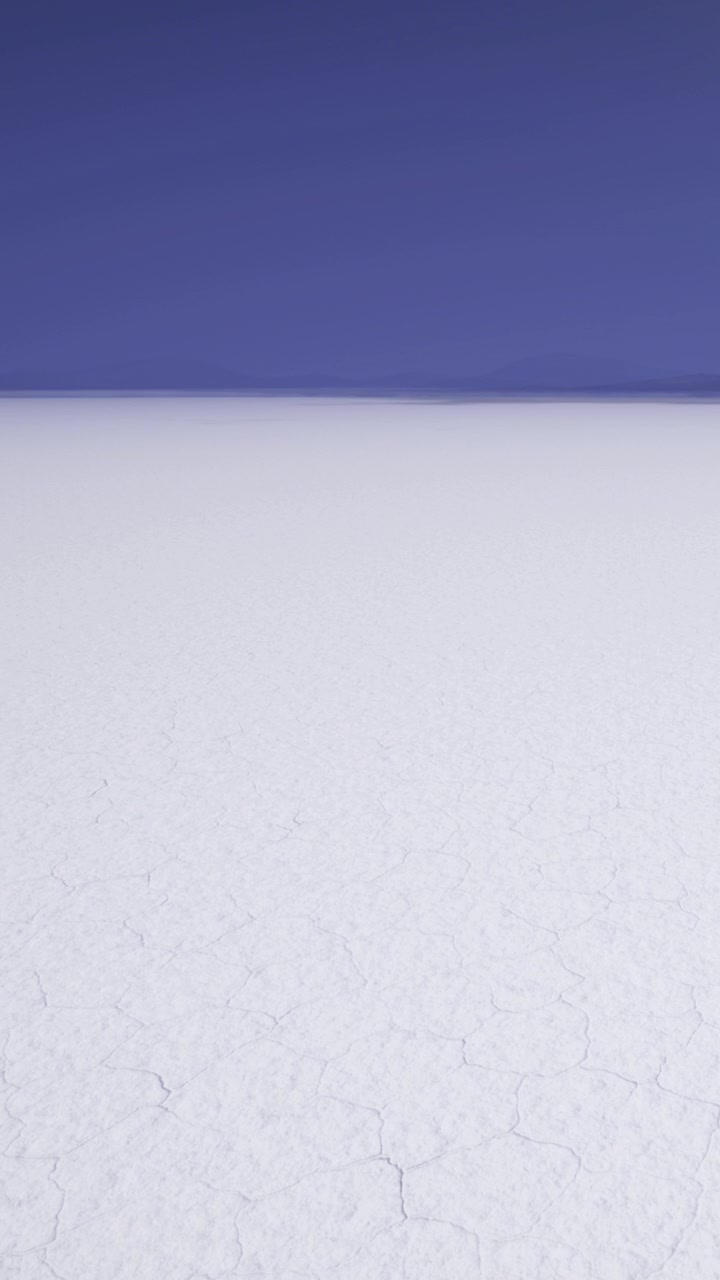 Expansive salt flat under clear sky in remote region of bolivia during daytime