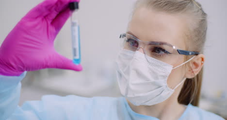 researcher holding covid 19 sample tube in hand 8