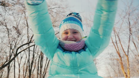 Cheerful-Little-Girl-Goes-On-A-Sled-Claps-His-Hands-Is-Happy-Winter-2