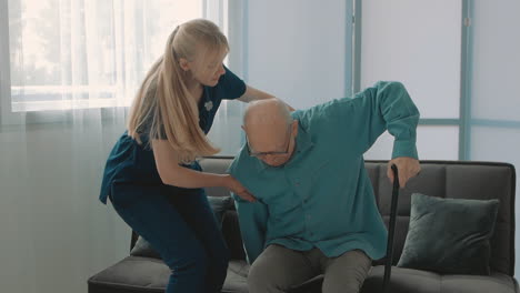 old man with cane, young caring nurse woman helps him