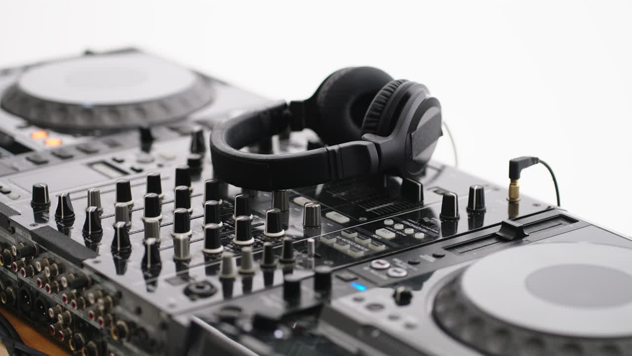 Close up of a DJ mixer with headphones on top