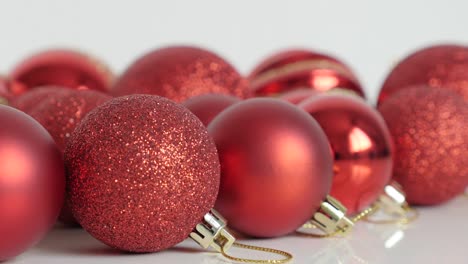 lot of red baubles on white close-up 4k footage