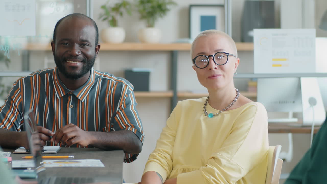 Portrait of Positive African American Man and Caucasian Woman in Office
