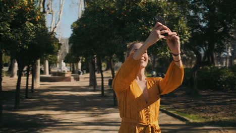 stylish young woman taking pictures outdoor.