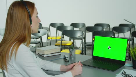 remote education, online education, remote studying, online learning concept. woman is using a laptop with green screen chroma key to conduct an online class.