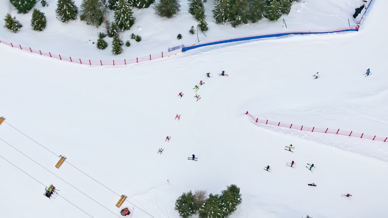 Aerial drone view of people having a ski lesson, at a ski resort in Corvara in Badia covered in snow, in South Tyrol, the Dolomites