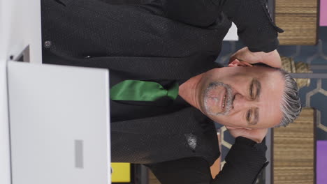 vertical video of businessman looking at camera tired from work.